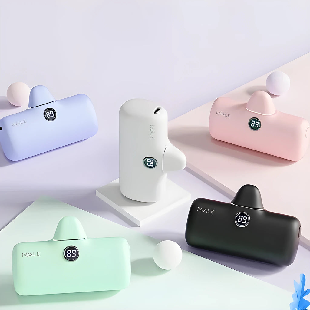 Compact white lipstick-shaped power bank showing screen display next to a smartphone.