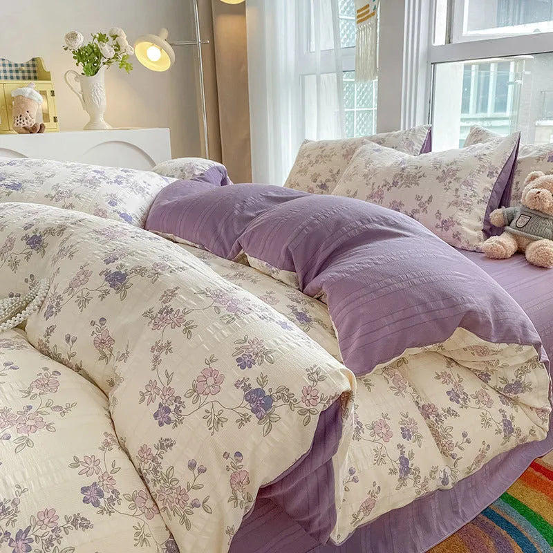 Aerobic jacquard cloud yarn four-piece bedding set with quilt cover, sheet, and pillowcases in a soft pattern.