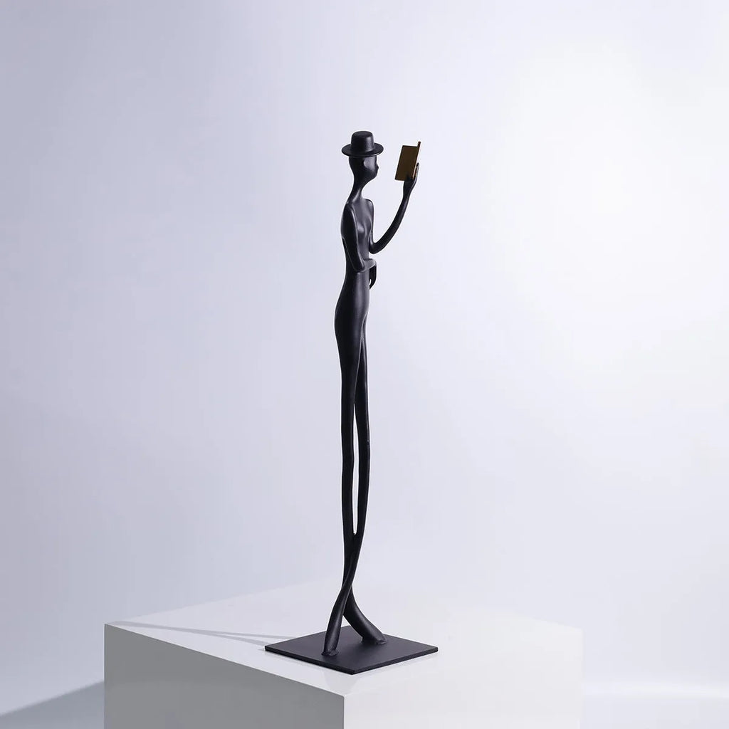Black cast aluminium desktop sculpture of a reading woman, modern simplicity style