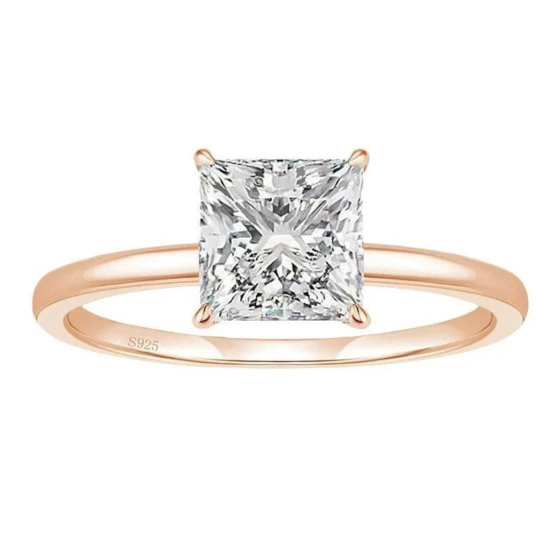 A 925 sterling silver ring with a single round cubic zirconia stone on a geometric band.