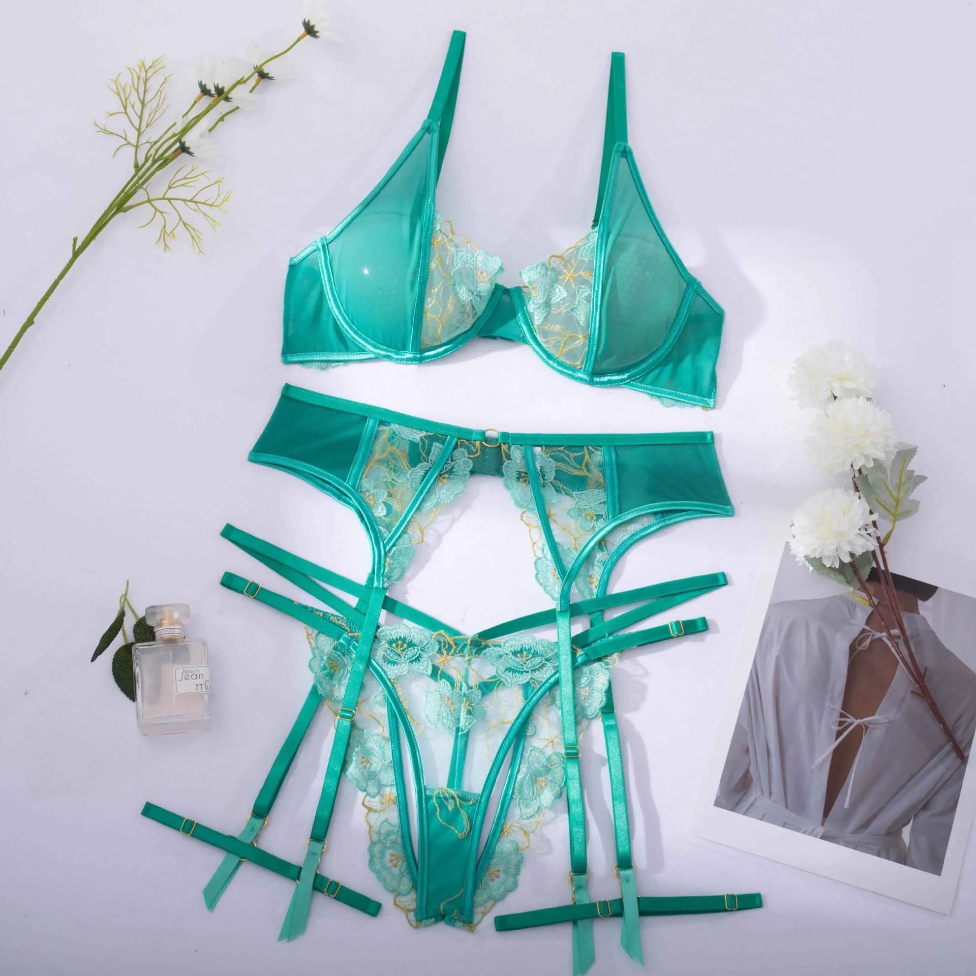 Light green women's embroidered bra set with three-point style and tights on a mannequin.