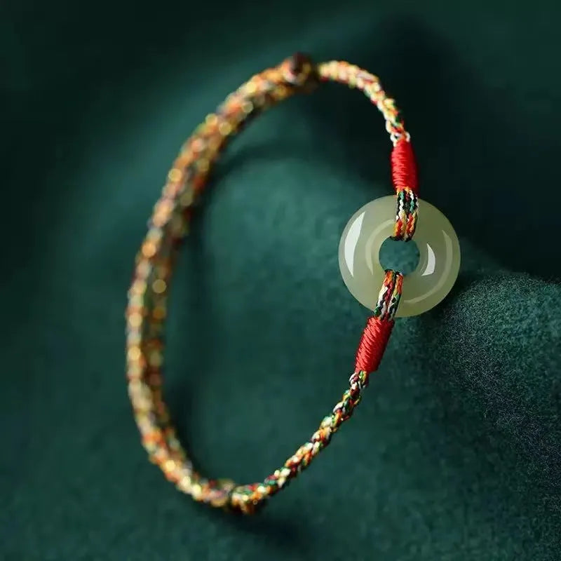 Colourful braided rope bracelet with peace buckle closure on woven design