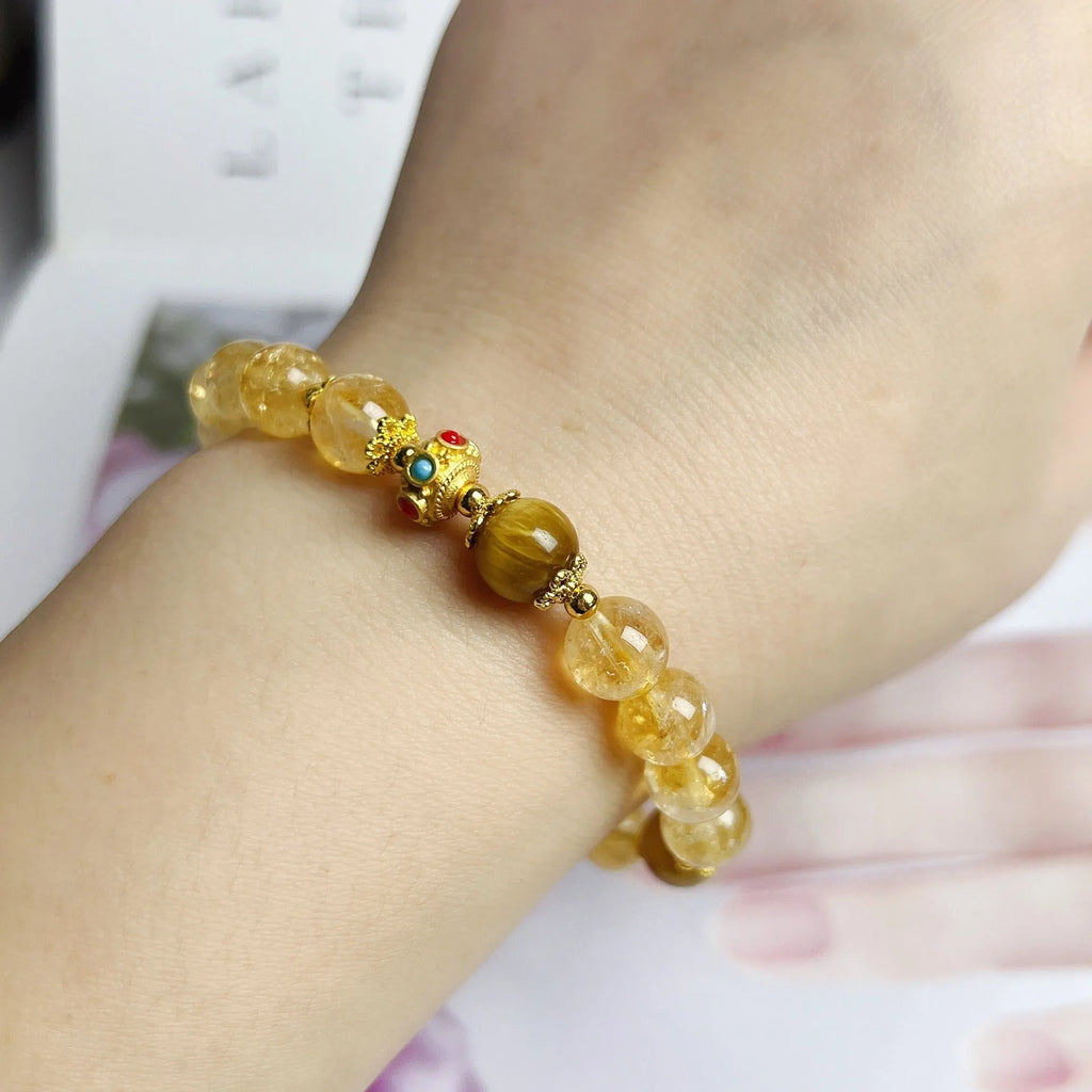Handmade citrine colour crystal bracelet with floral and tassel detailing for women.
