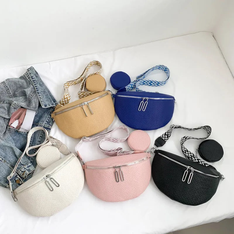 Solid colour women's crossbody bag with saddle lock detail, shown in a horizontal square clamshell shape.