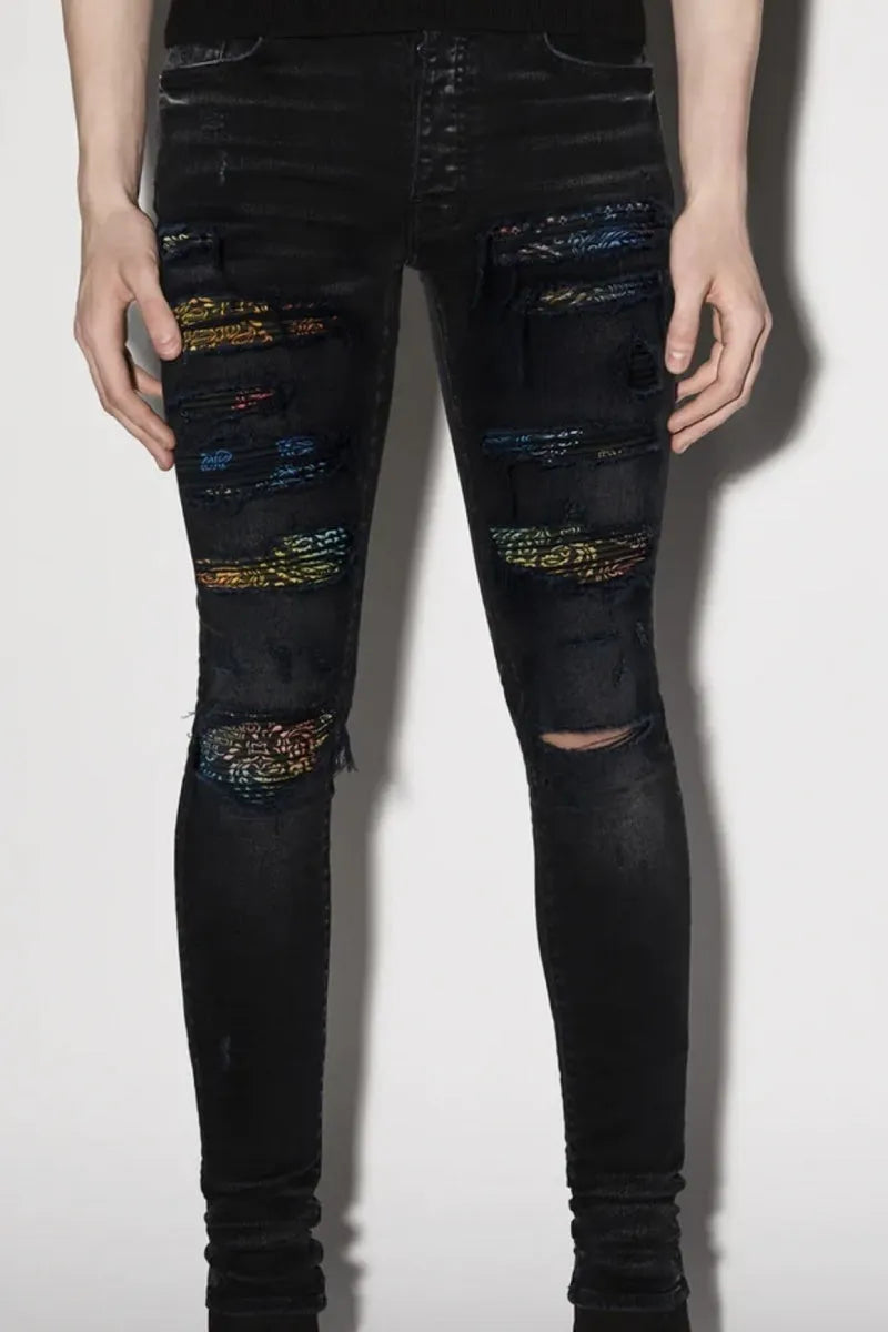 Men's black denim jeans with tattered hem and simple print patch detail
