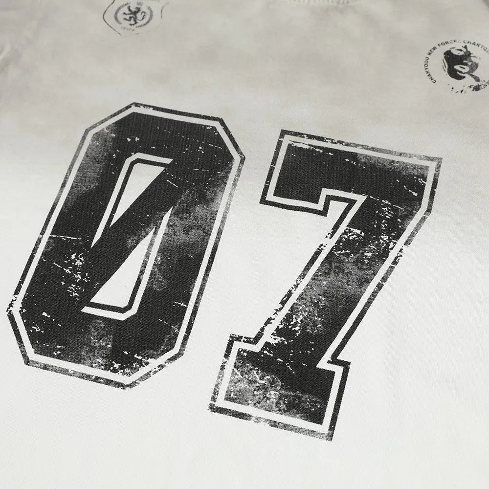 Men's black and white printed short-sleeve cotton t-shirt laid flat, showing sizes S, M, L, XL.