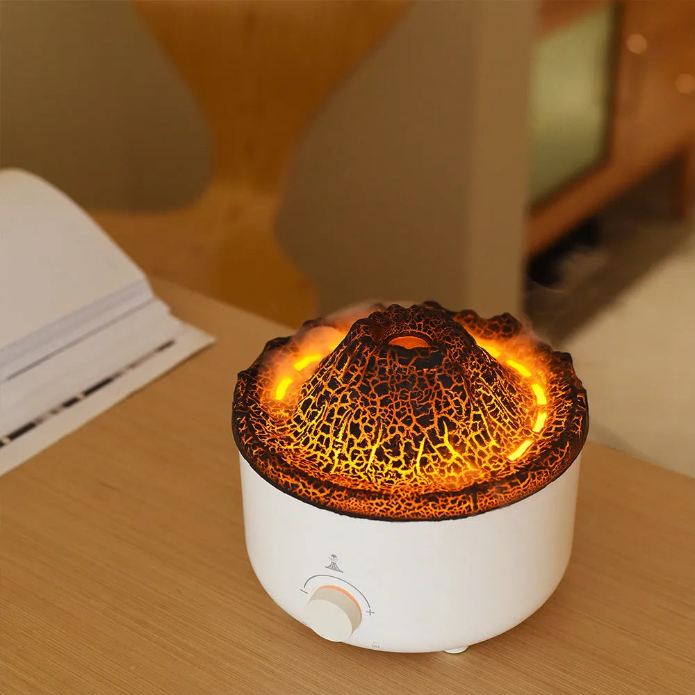 Small white volcano-shaped humidifier with simulated flame lighting and remote control on wooden table