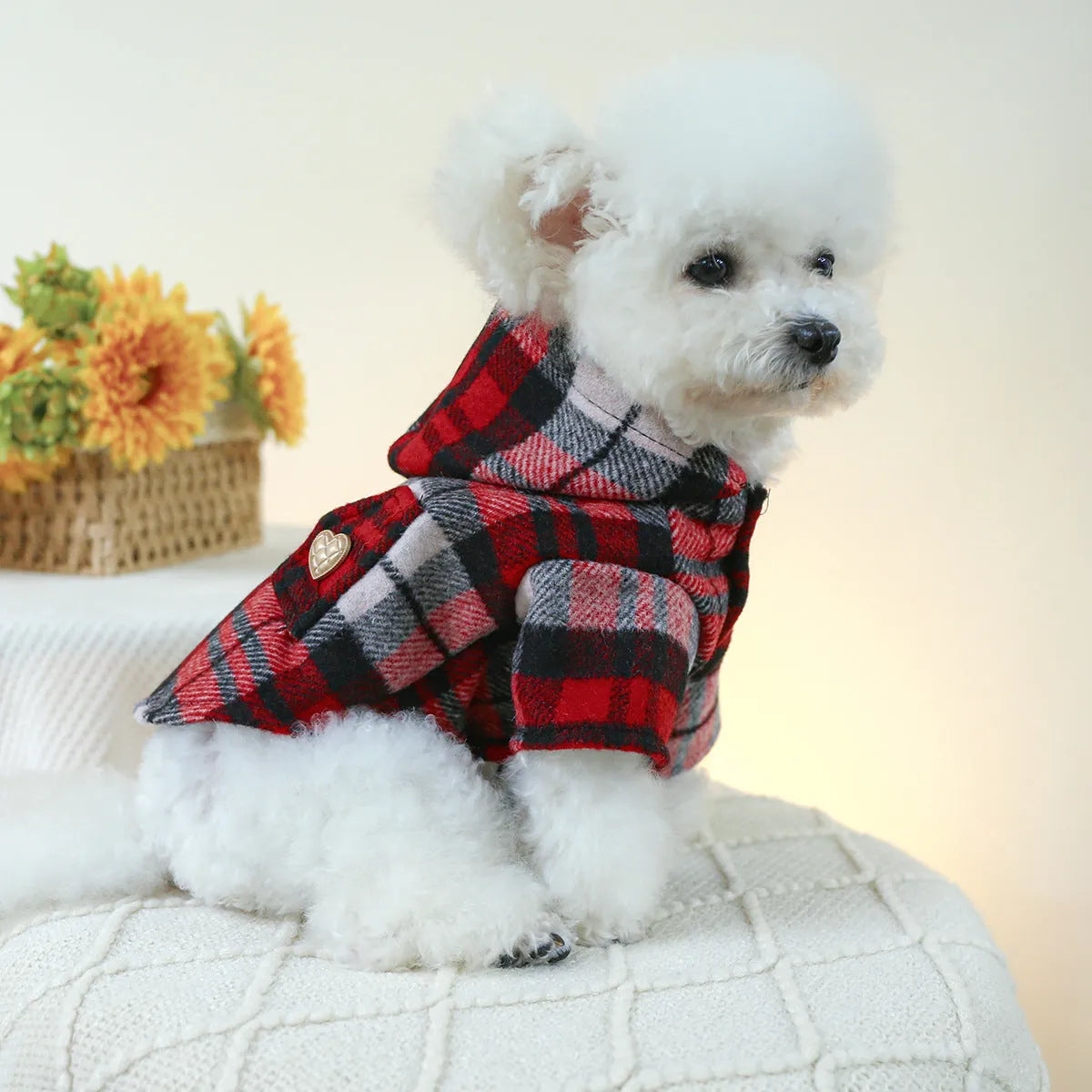 Red plaid trench coat for a dog, shown alongside a black houndstooth version, on a mannequin.