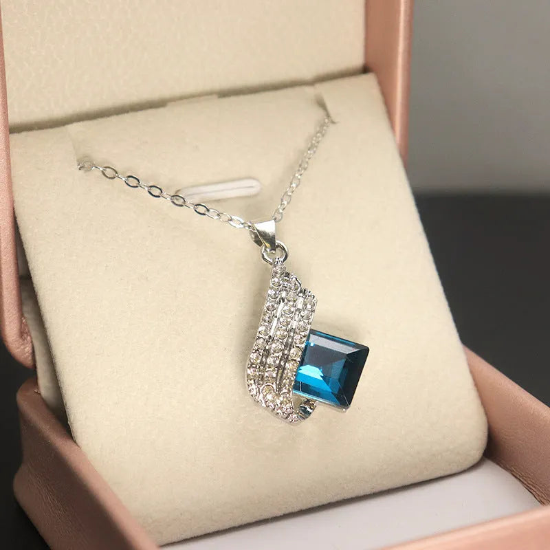 Women's electroplated necklace and earring set with alloy pendant and glass accents on cross chain