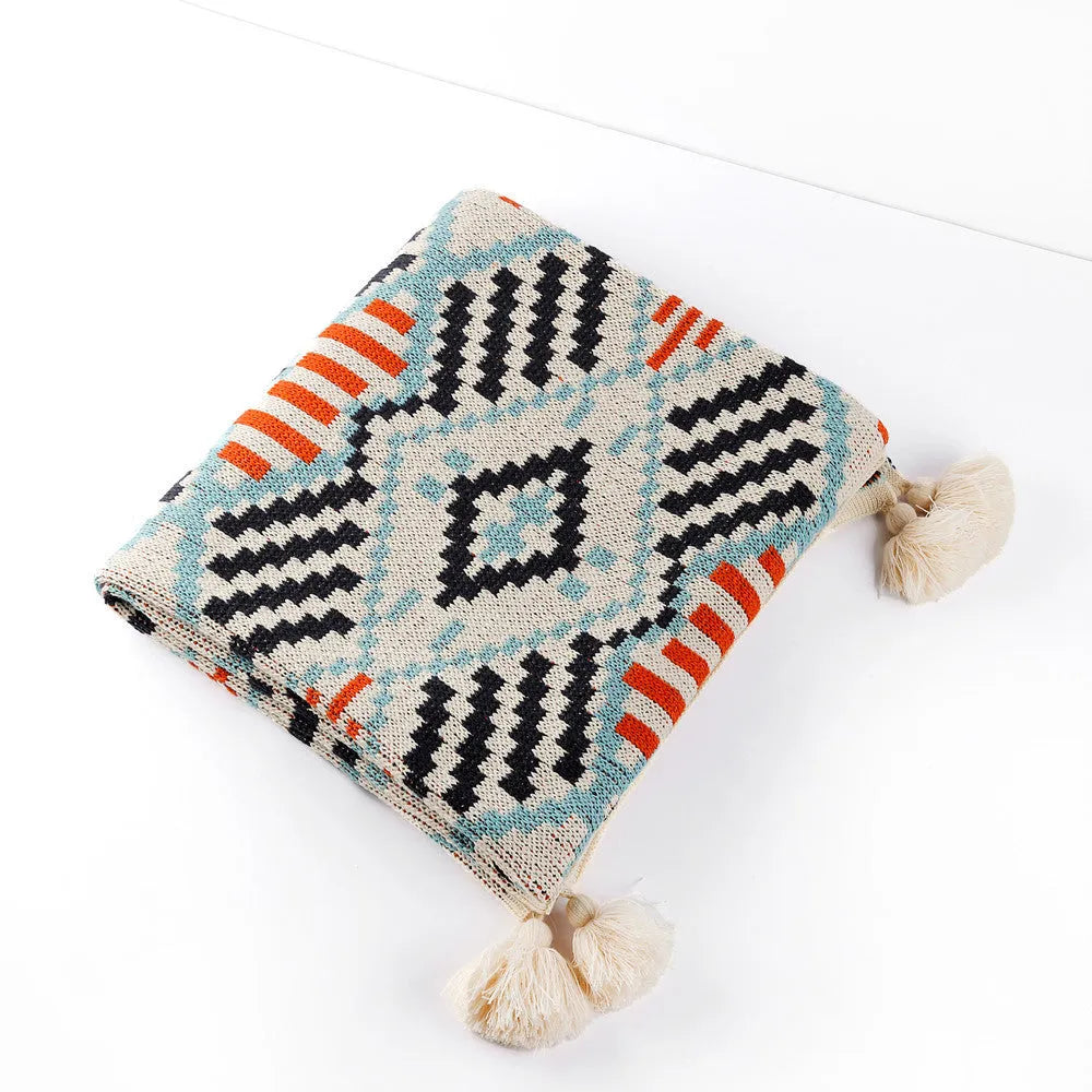 Acrylic bohemian-style blanket with tassel trim in a geometric pattern colour option