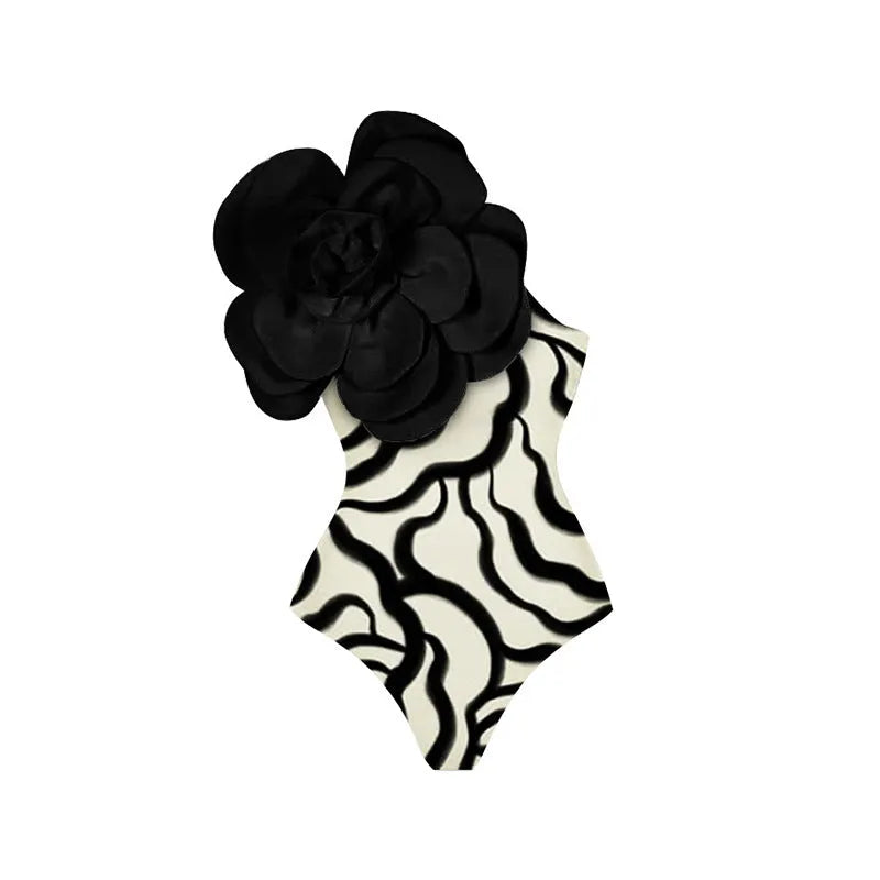 Black one-piece swimsuit with three-dimensional white floral pattern on a mannequin.