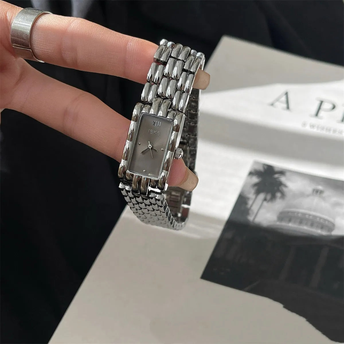 Women's bracelet watch with butterfly clasp showing 15mm dial and stainless steel case