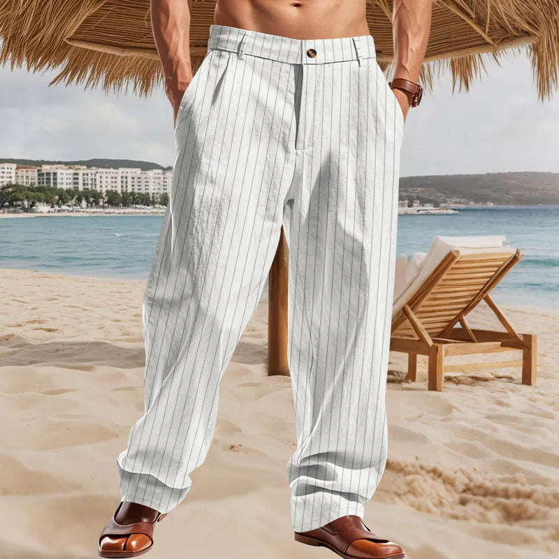 Man wearing beige striped linen trousers with a high waist and wide loose legs.
