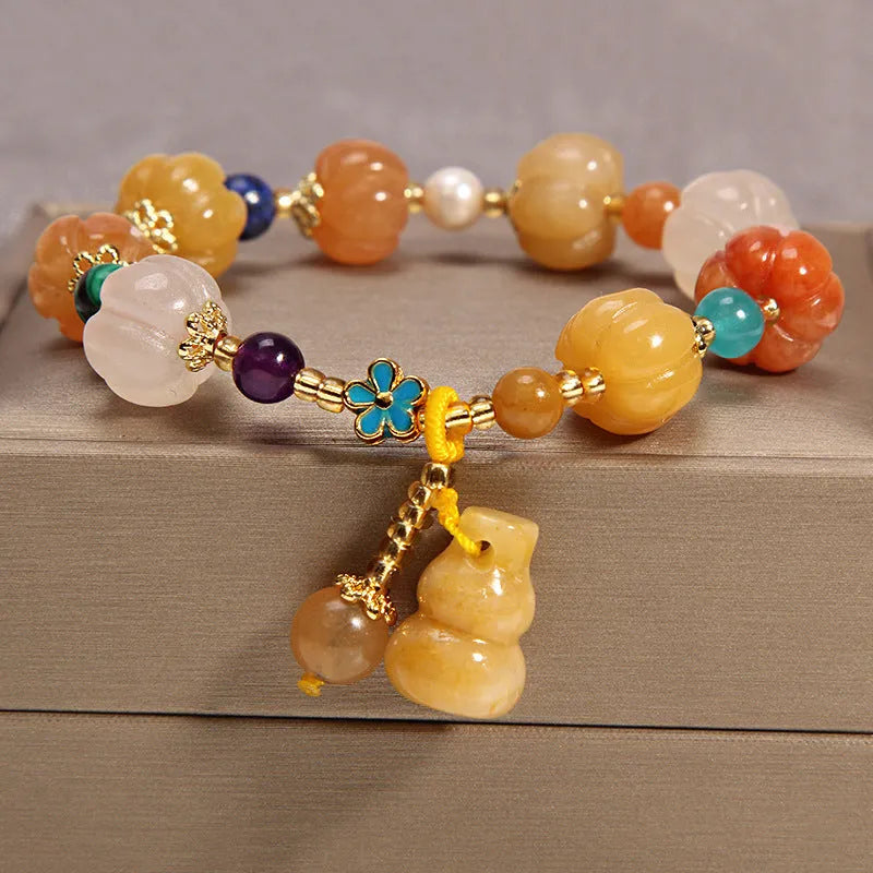 Yellow agate crystal bracelet with gold silk cord on wrist showing adjustable closure and bead detail