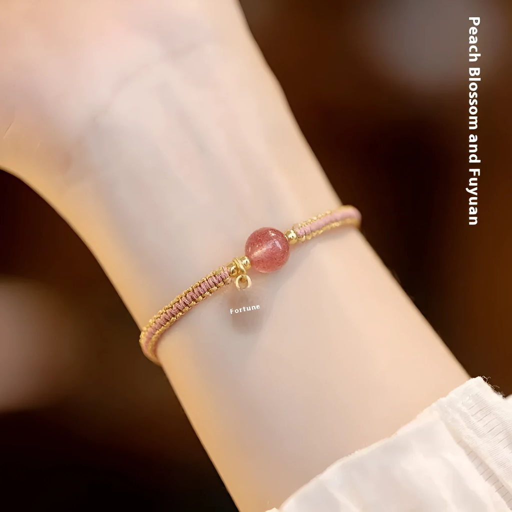 Adjustable red rope bracelet with sliding strawberry quartz bead in national tide style.