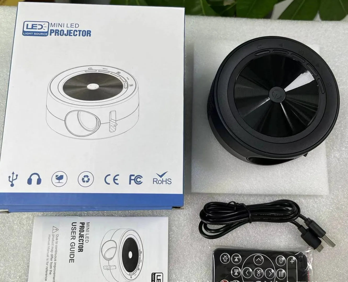 YT200 portable home LED projector with same screen connectivity in black, white, yellow and white, or blue and white colours measuring 110mm x 47mm