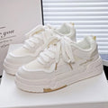 Beige children's board shoes with thick rubber soles, cross shoulder straps, and front laces on a synthetic leather upper.