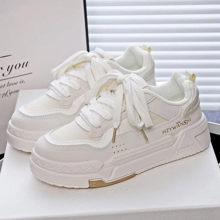 Beige children's board shoes with thick rubber soles, cross shoulder straps, and front laces on a synthetic leather upper.