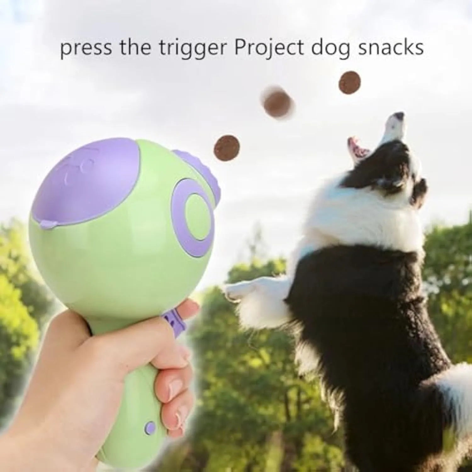 Green, orange, and pink dog treat launcher toy for interactive feeding and training.