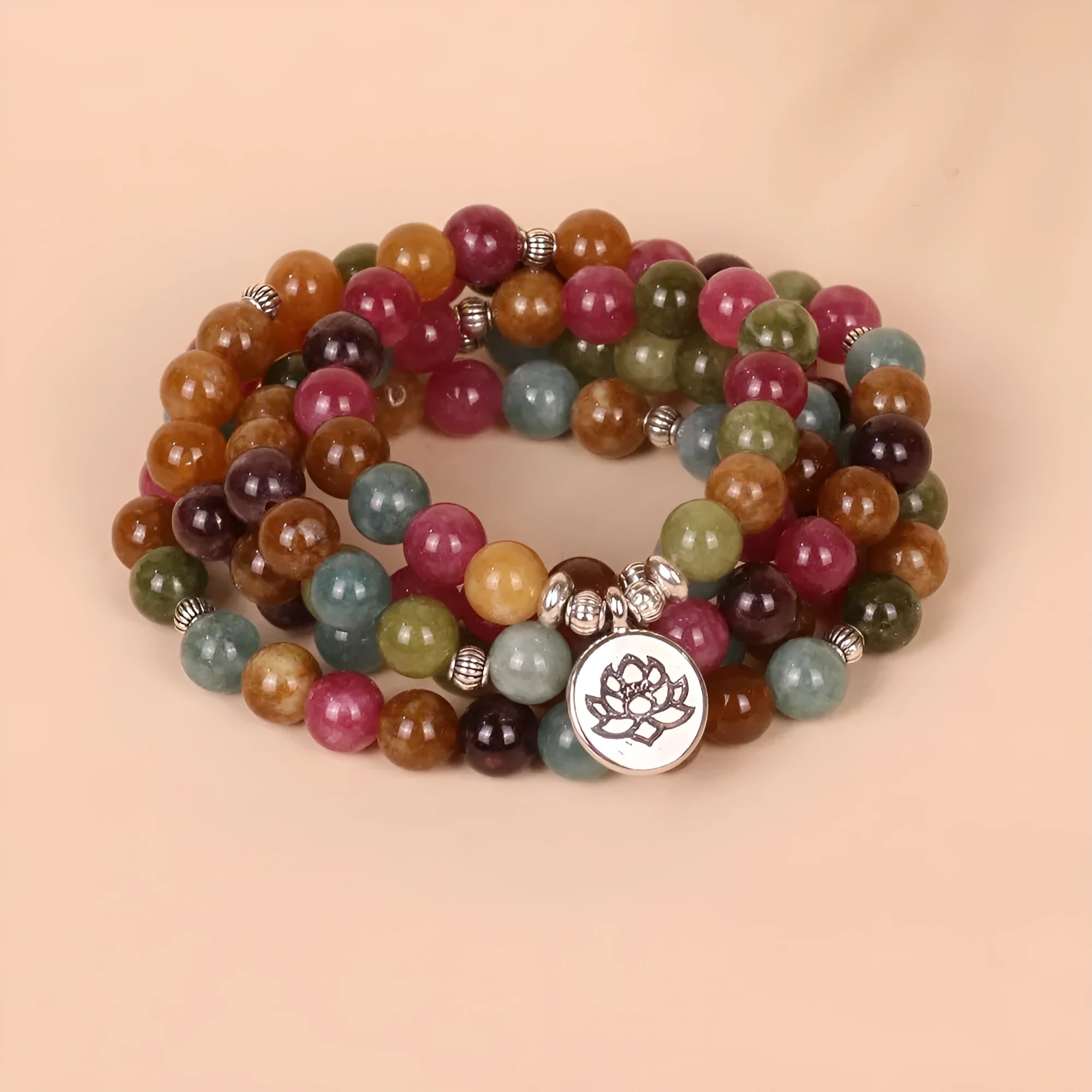 108-bead multi-layer bracelet with hanging lotus ornament in tourmaline-coloured alloy.