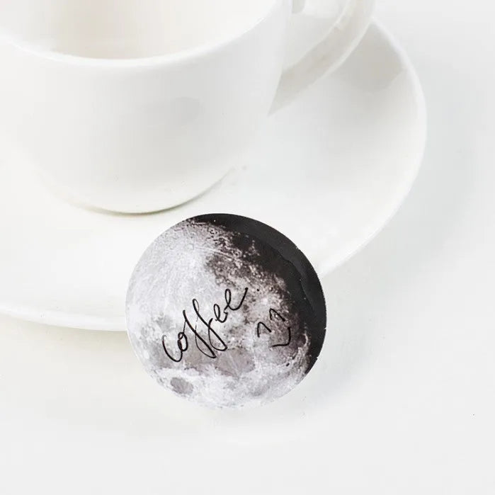 Black decorative stickers showing moon phases, calendar planets and hand account designs