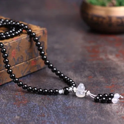Black agate stone bead bracelet with 108 geometrically shaped beads and number element details