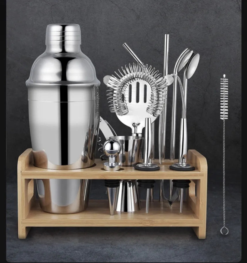 23-piece stainless steel and acrylic European style cocktail mixing set on a bar.