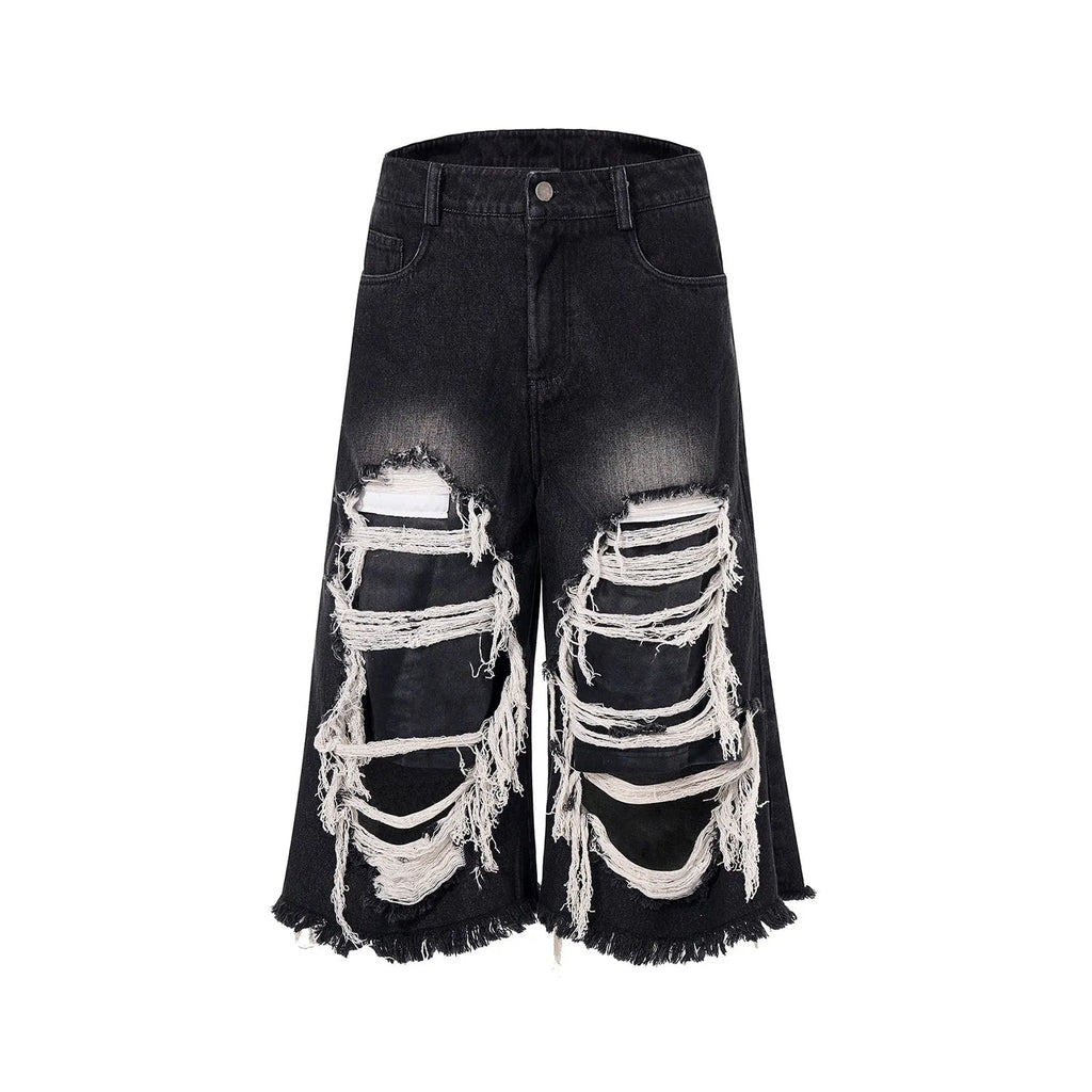 Black cropped wide-leg jeans with mid-high waist and distressed patch detail on micro-elastic denim