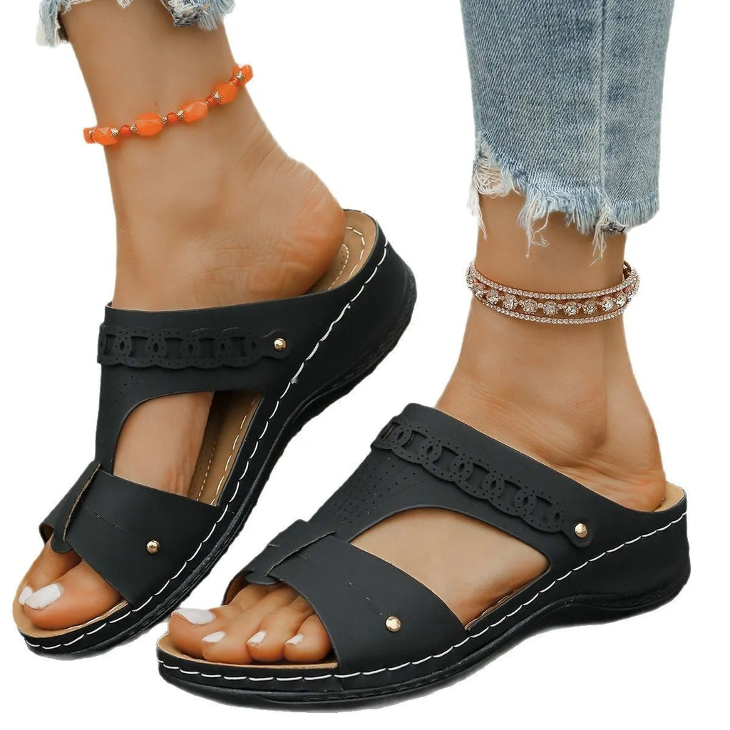 Roman-style slippers with a slope heel and fish mouth toe design in PU leather, shown in beige colour.