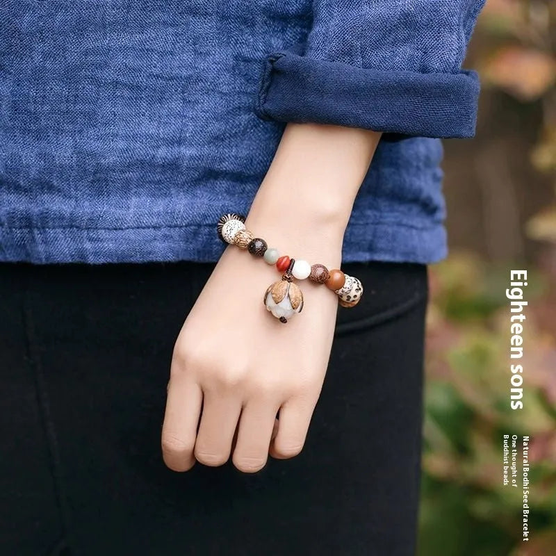 Handmade rudraksha bead bracelet with 18 seeds on a string, showing 16 cm loop.