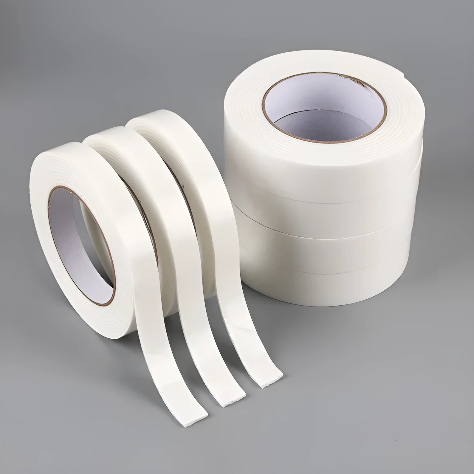 Roll of white foam double-sided adhesive tape showing its thickness, with size options 15mm, 18mm, and 30mm wide.