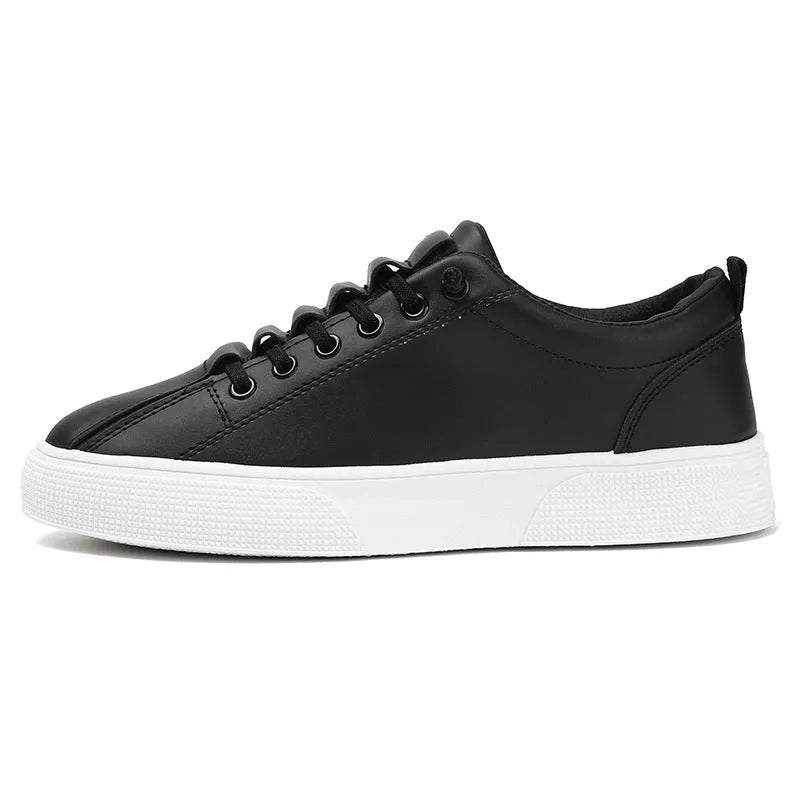 Men's black and white low top synthetic leather sports shoes with PVC sole on a plain background.