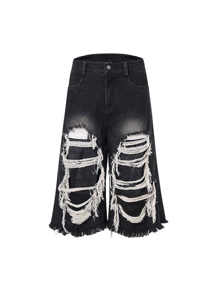 Black cropped wide-leg jeans with mid-high waist and distressed patch detail on micro-elastic denim