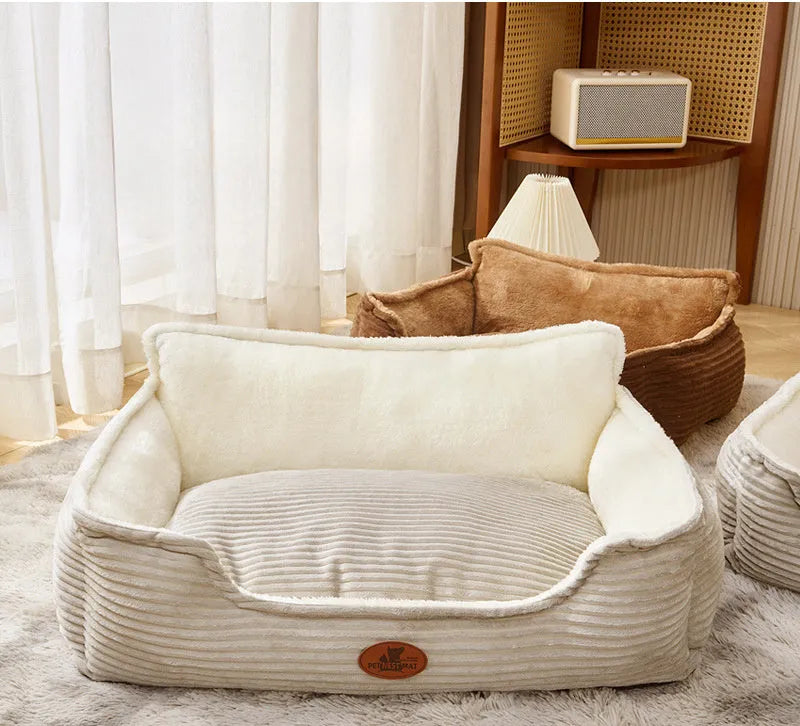 Coffee and white coloured removable washable dog kennel bed shown in small and medium sizes on a sofa and floor.
