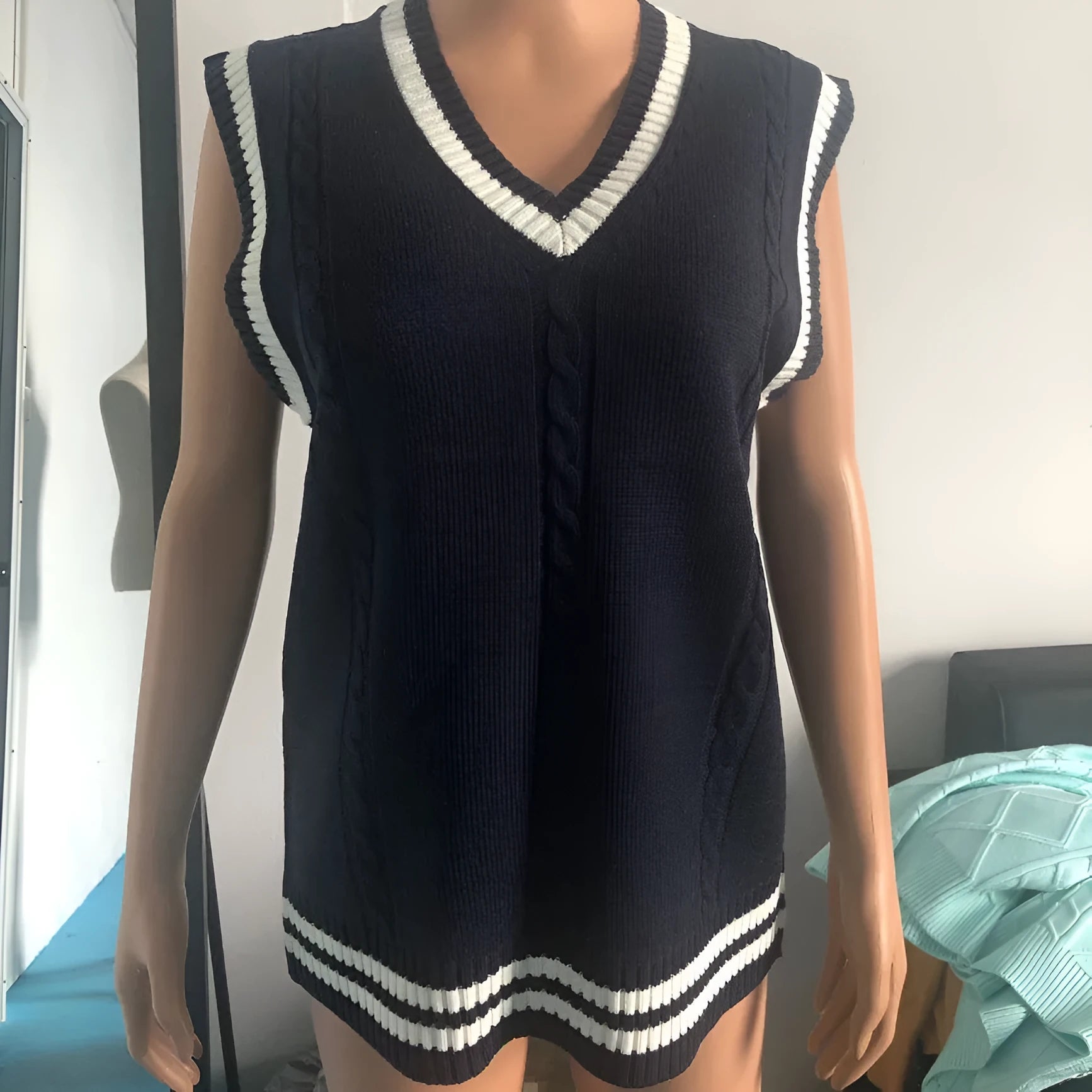 Women's slim fit acrylic knitted sweater with V-neck waistcoat style and striped stitching detail in dark blue colour