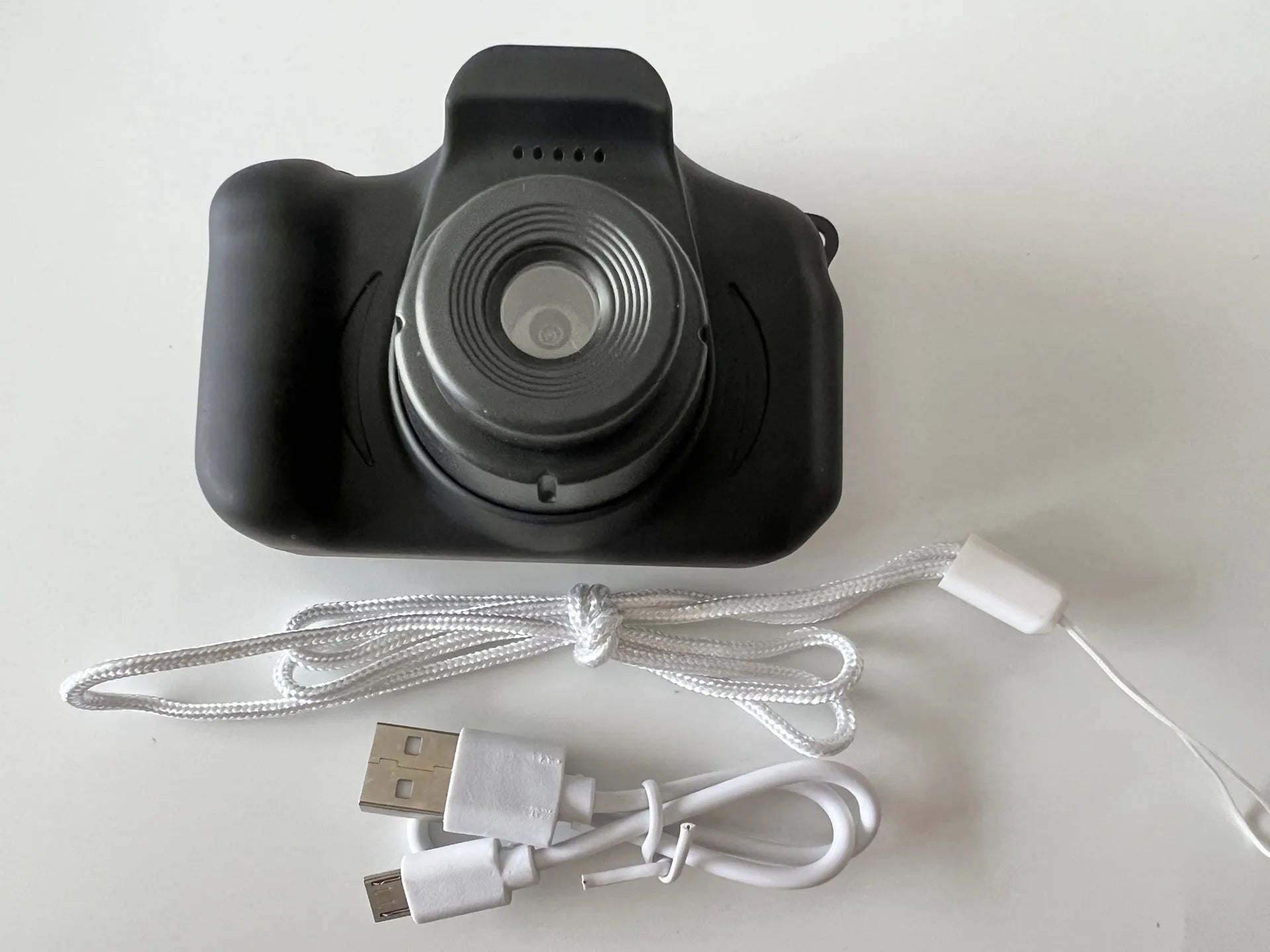 X2 HD mini cartoon kids digital camera in silicone body with 2-inch screen and lanyard.
