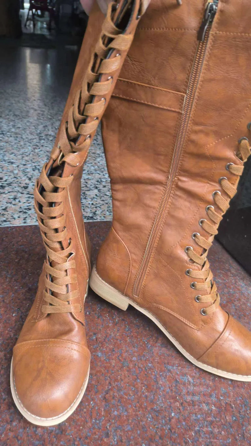 Women's black knight ankle boots with cross strap detailing, made from PU leather.