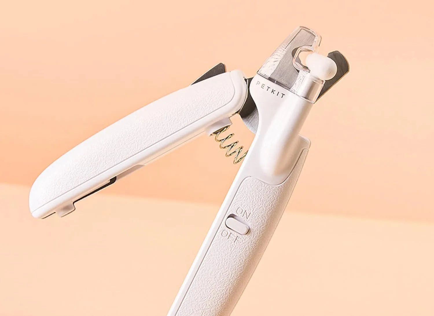 White LED pet nail clippers for cats and dogs with open transparent safety guard and nail file.
