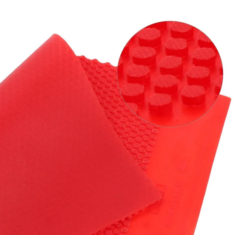 Single sheet of small pips-out table tennis rubber in black and red colour options.