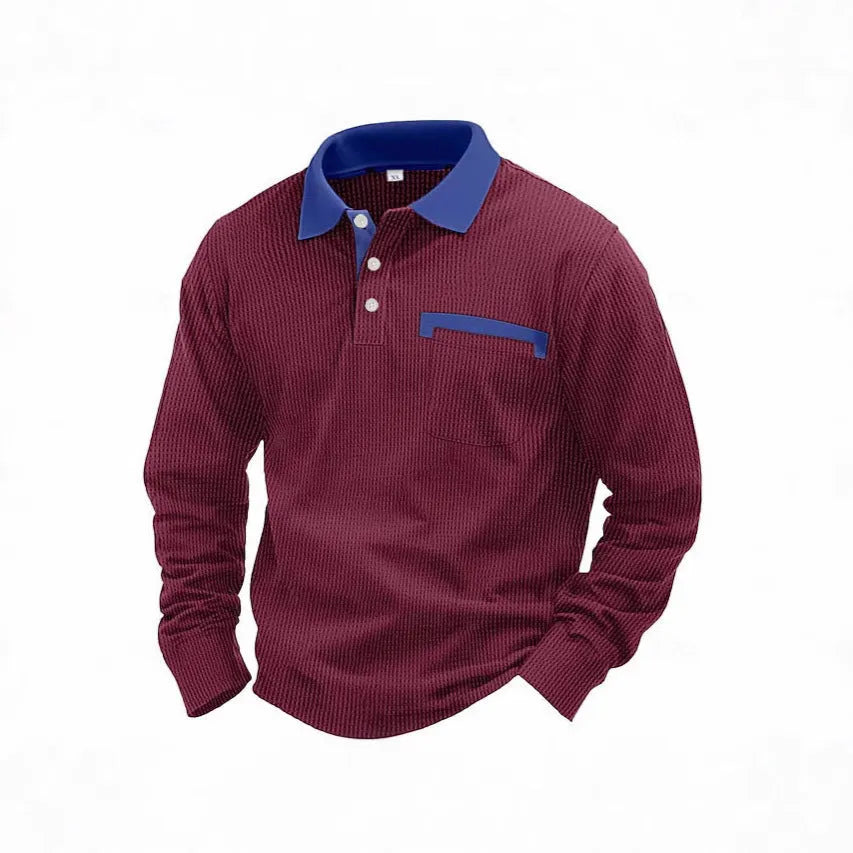Man wearing a long-sleeved waffle-textured polo shirt in a loose fit, shown in a dark colour.