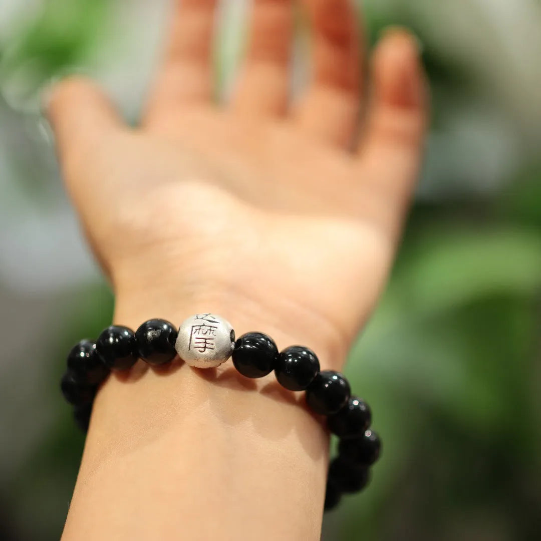Handmade black agate bead bracelet with sterling silver on a wrist