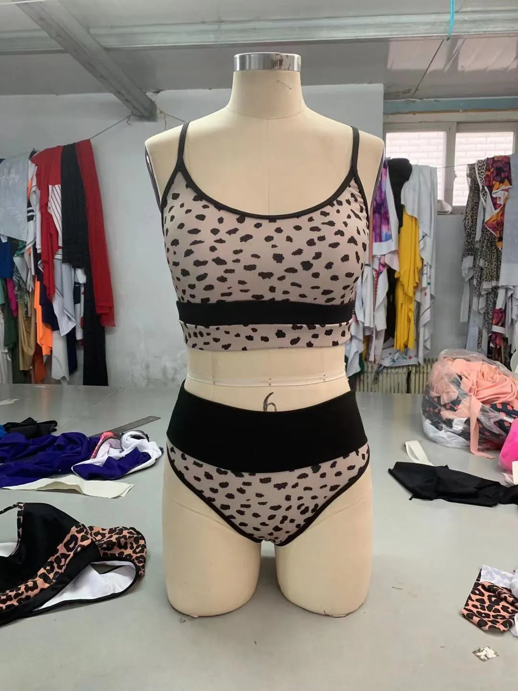 Women's high waisted leopard print bikini set with matching top on a mannequin.