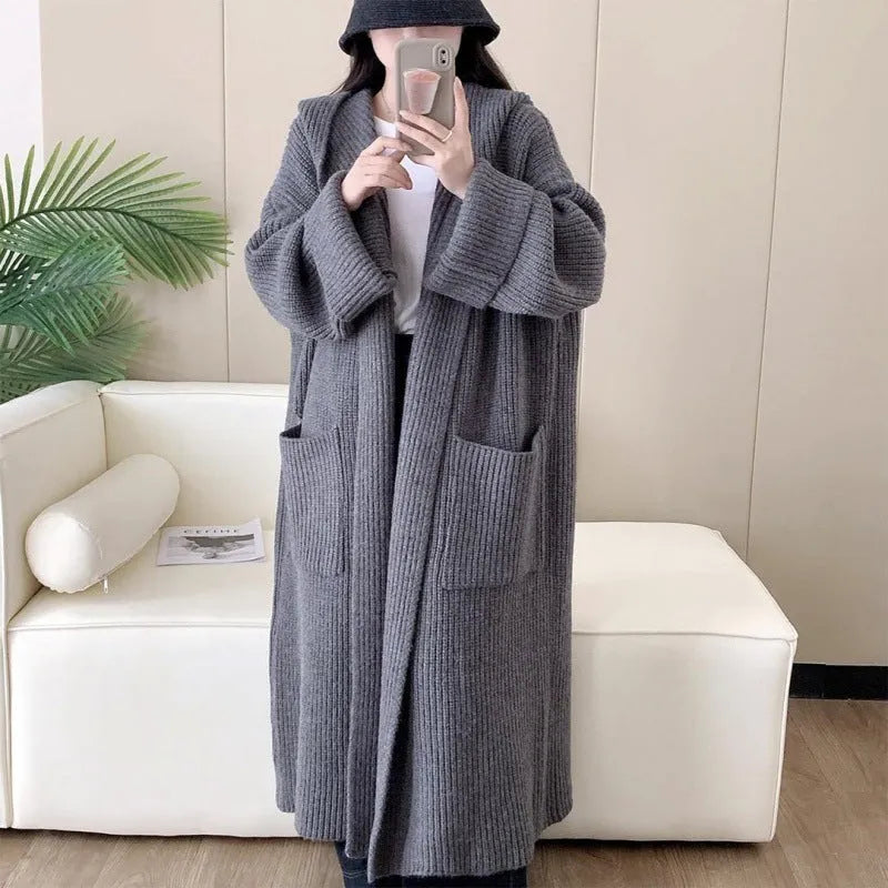 Women's loose grey hooded acrylic cardigan coat with long sleeves, shown open.