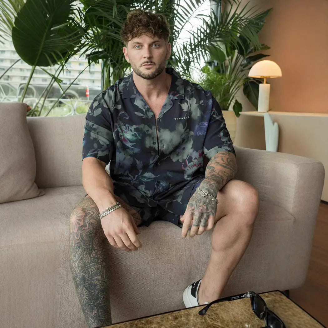 Man wearing a loose, short-sleeve floral print casual top in a cardigan style.