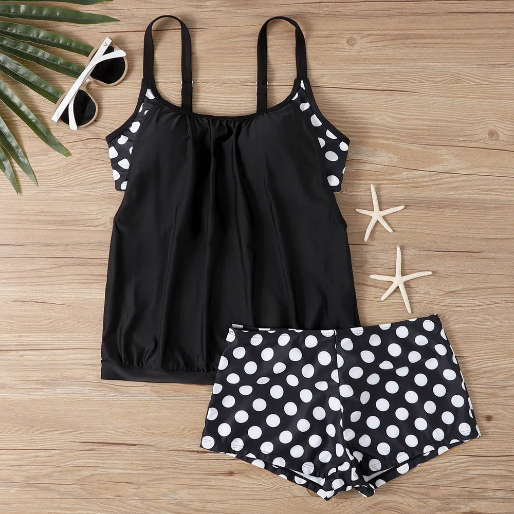Women's black polka dot high-waist boxer swimsuit top and pants set on a mannequin.