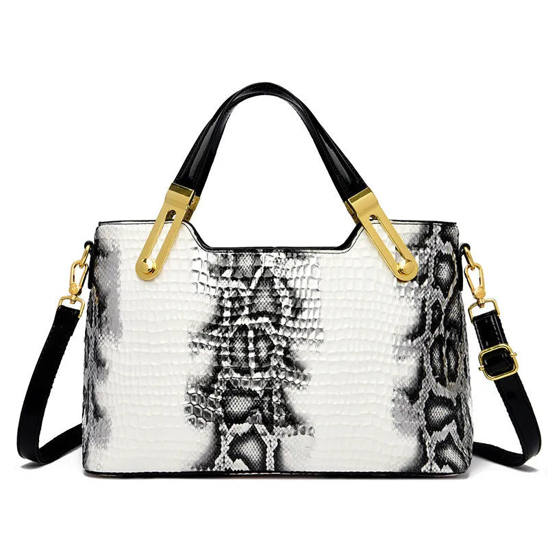Retro black and white messenger bags with chain detail, showing internal phone and file compartments.