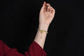 Natural Hetian jade bracelet with a carved Fu character charm on a wrist.