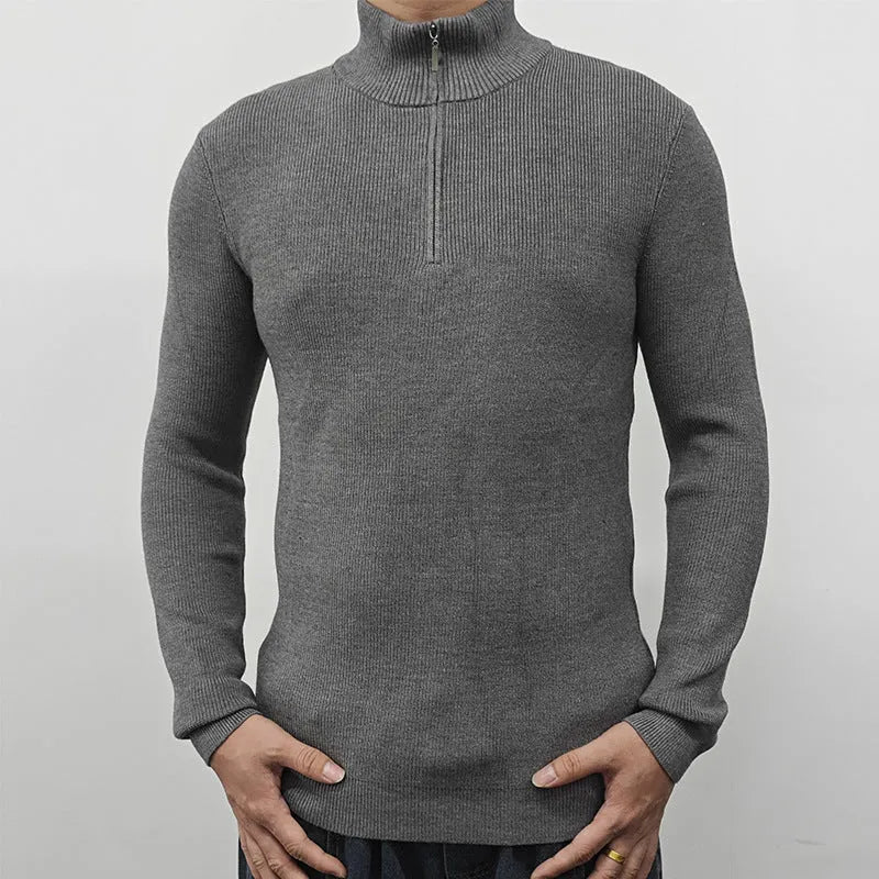 Man wearing a grey half-turtleneck zipper sweater, long sleeves, casual style.
