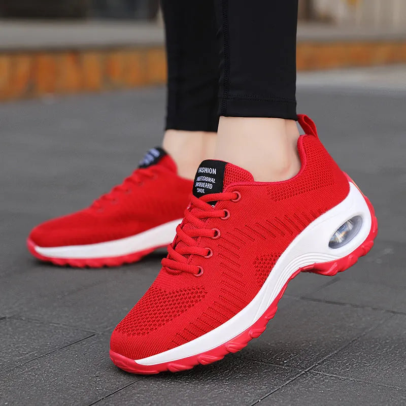 Red women's low-top mesh sneakers with front laces and a round toe on a flat PU sole.
