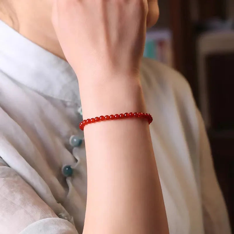 A classic style ultra-thin red agate bracelet for women on a white background.